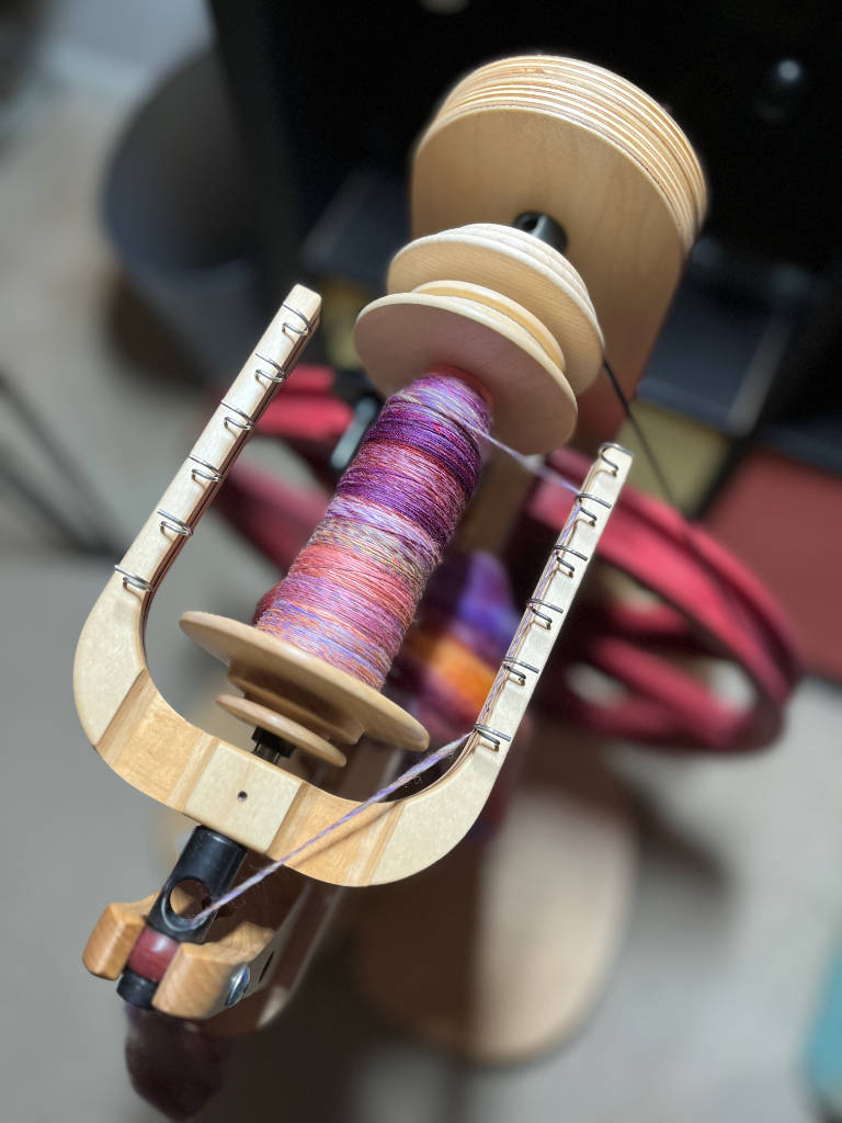 Merino Malabrigo hand spun single on a bobbin.