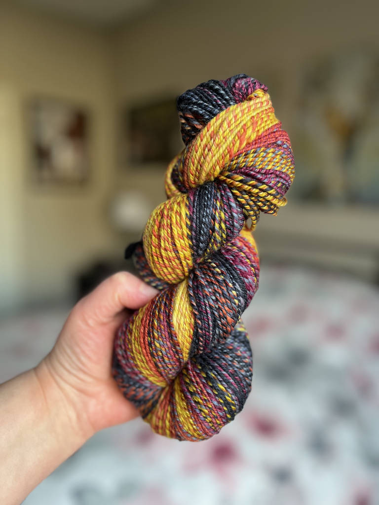 Merino hand spun yarn in navy, maroon and gold.